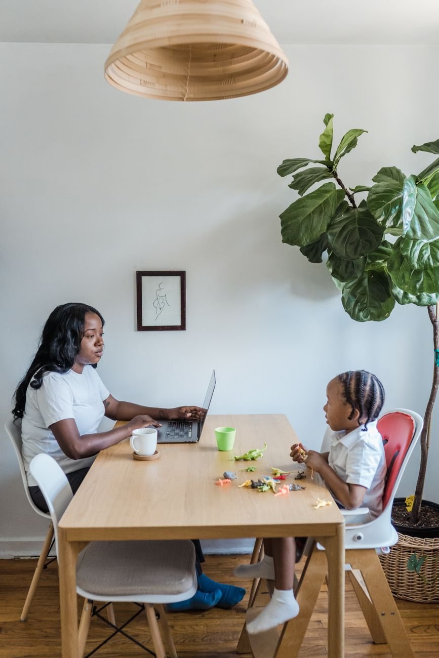 Mother working with child at home in a calm, organized setting — the peace of mind a plan provides.